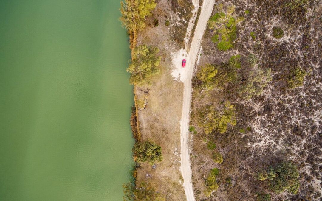 looking-down-small-red-car-parked-shore-murray-river-south-australia